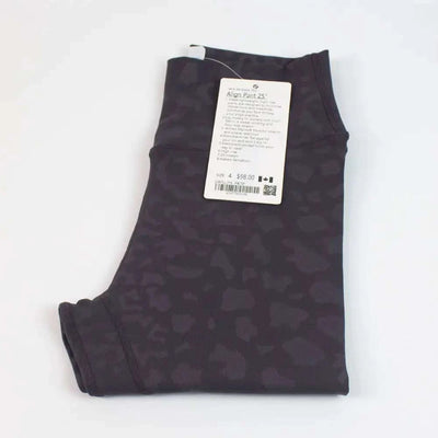 Folded High Waist Hip Lift trousers in dark pattern with a tag attached.