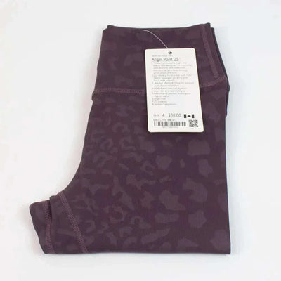 High Waist Hip Lift trousers in patterned fabric with attached tag.