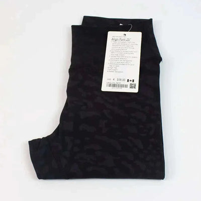 High Waist Hip Lift trousers in black, folded with a price tag attached.