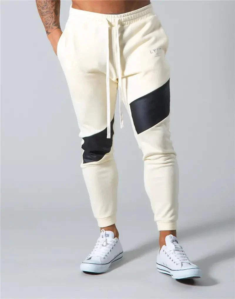 Trendy men's slim fit casual exercise trousers in beige with black accents, showcasing style and comfort.