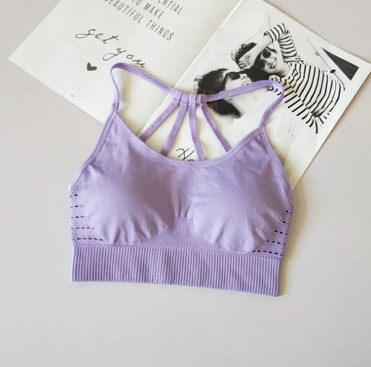 Violet sport bra for fitness and yoga with stylish back design.