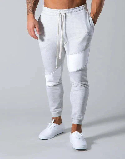 Trendy men's slim fit casual exercise trousers in grey with drawstring waist, highlighting comfort and style.