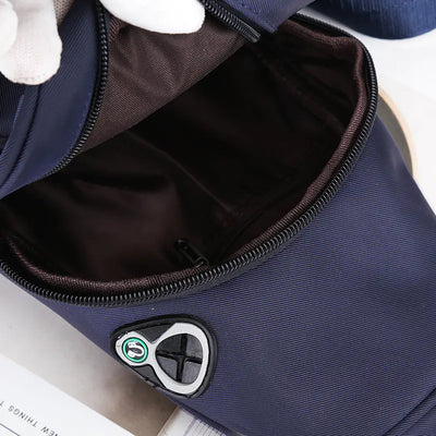 Navy blue sport shoulder bag with headphone jack and open zipper, made of durable oxford cloth for outdoor use.