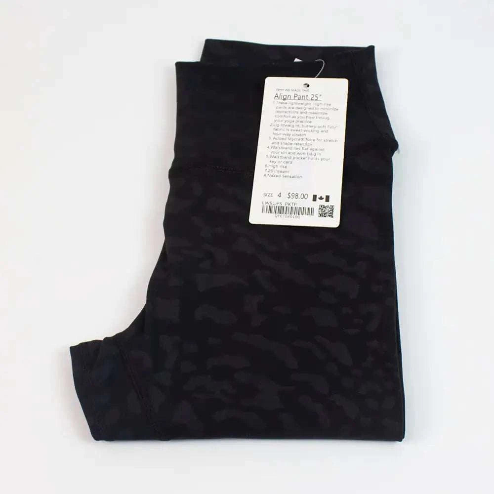 High Waist Hip Lift trousers in black, folded with a price tag.